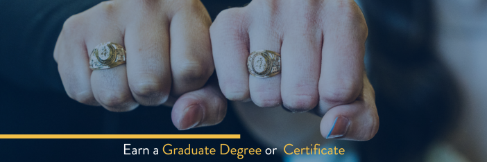 Two hands with graduation rings